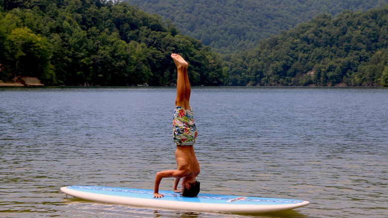 A person balancing on a paddleboard