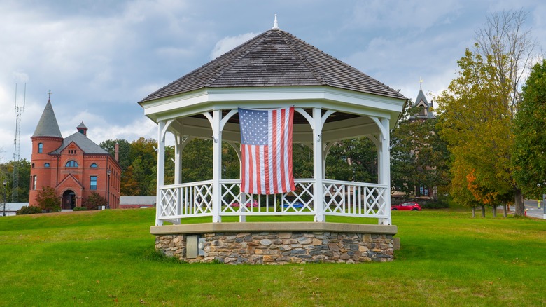 The historic bandstand at Princeton Common in historic town center of Princeton, Massachusetts with a view of the old Town Hall in the background.