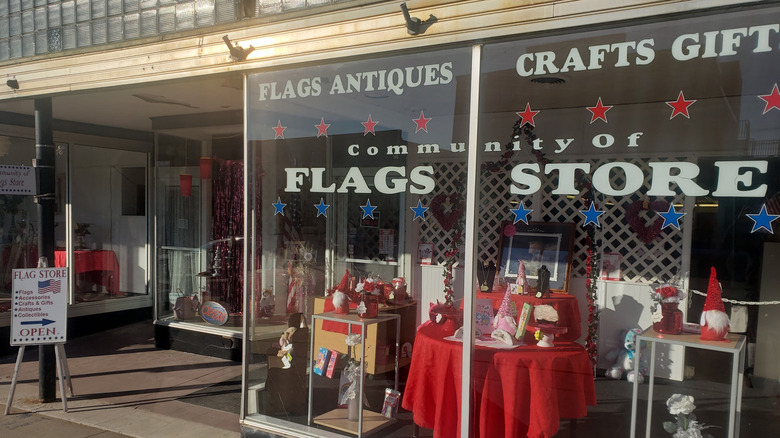 The entrance to the Community of Flags store in Brooklyn, Iowa with signage and displays