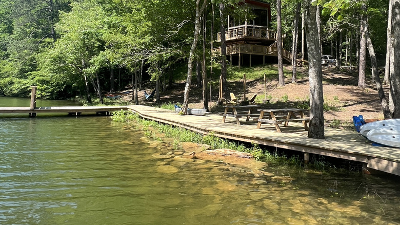 house in background with lake and dock in front