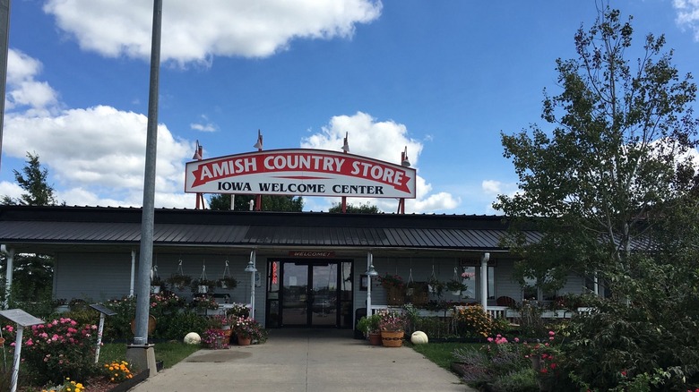 Entrance of Amish Country Store in Iowa with a sign on top of a one-story building