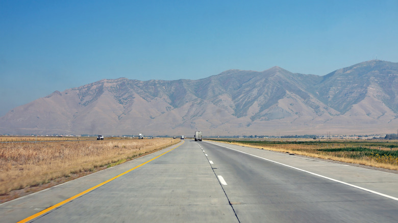 Driving to Oquirrh Mountain range by US route 80 highway on sunny day