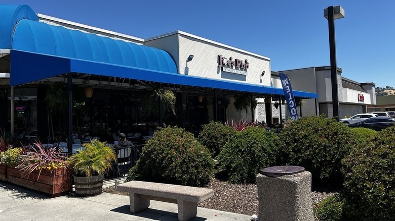 Exterior of Joe's Pho with a blue awning in Ashland, California