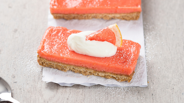 A slice of the grapefruit pie, topped with whipped cream