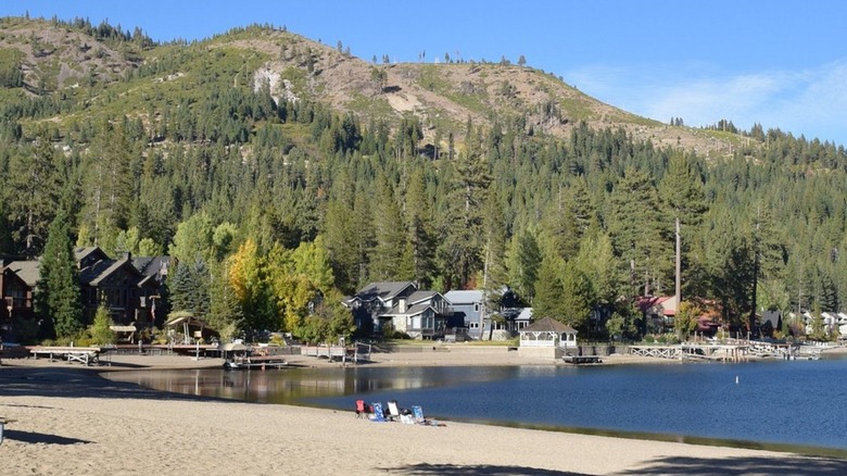An image of West End Beach on Donner Lake with mountains and homes in the background