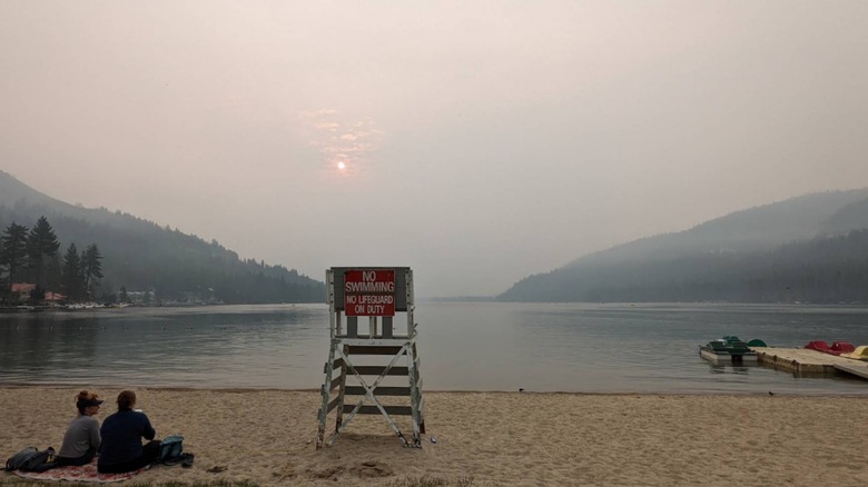 An image of Donner Lake from West End Beach Park with a dock and paddle boats in the distance