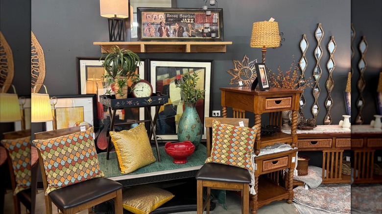 Pre-loved home decor items like accent pillows, chairs, lamps, and frames in a second-hand store in Spirit Lake, Iowa