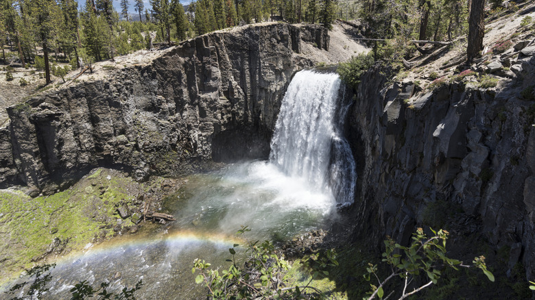 Rainbow Falls with rainbow against volcanic cliffs
