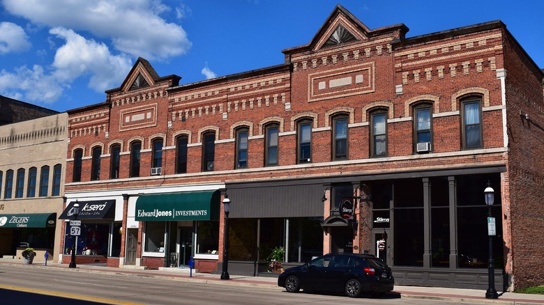 Red brick two-story buildings with businesses on the ground floor in De Pere, Wisconsin