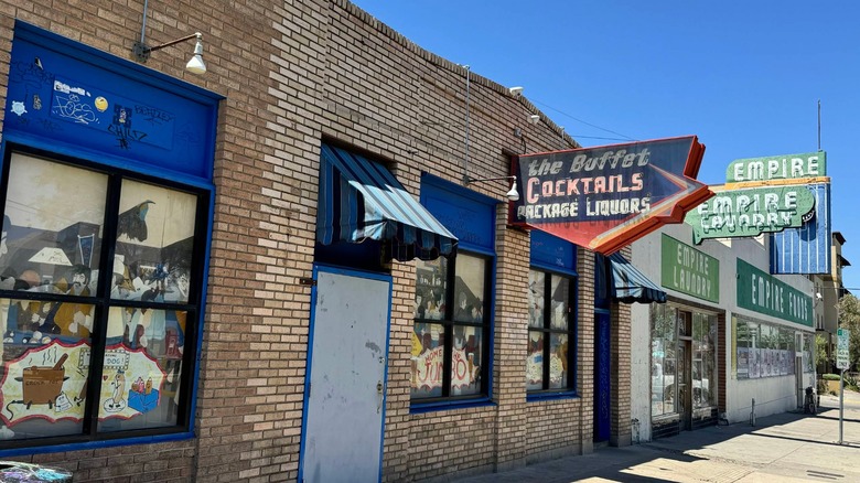 Neon signs of the Buffet and Empire Laundry and Market with blue sky
