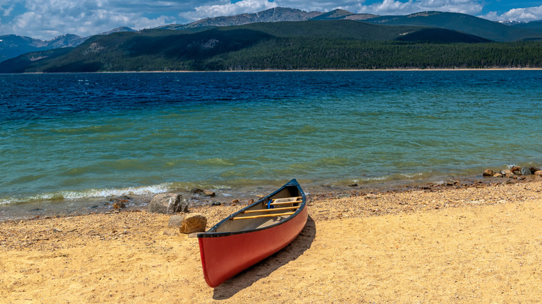 A red canoe on the shore of Turquoise Lake