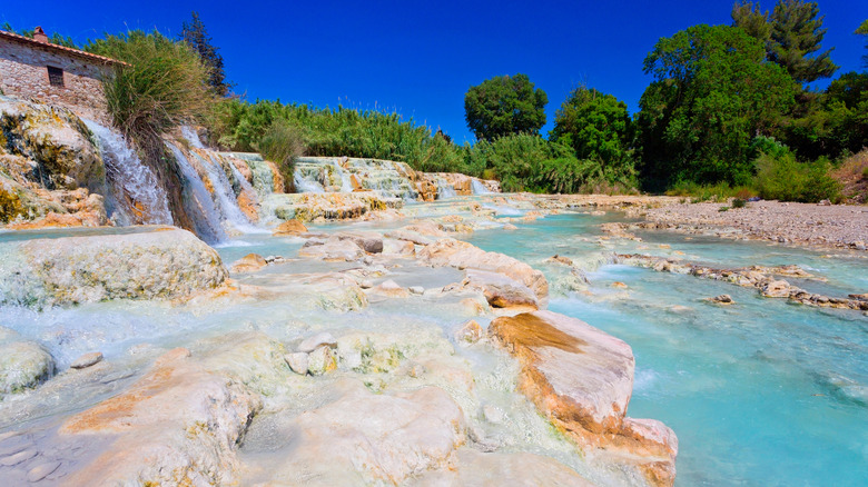 The bright blue thermal pools of Cascate del Mulino in Saturnia, Italy