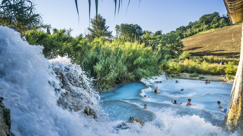 People bathing in the terraced pools of Cascate del Mulino in Saturnia, Italy