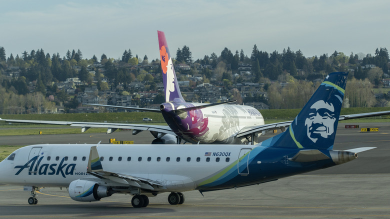 Alaska Airlines and Hawaiian Airlines planes on a runway