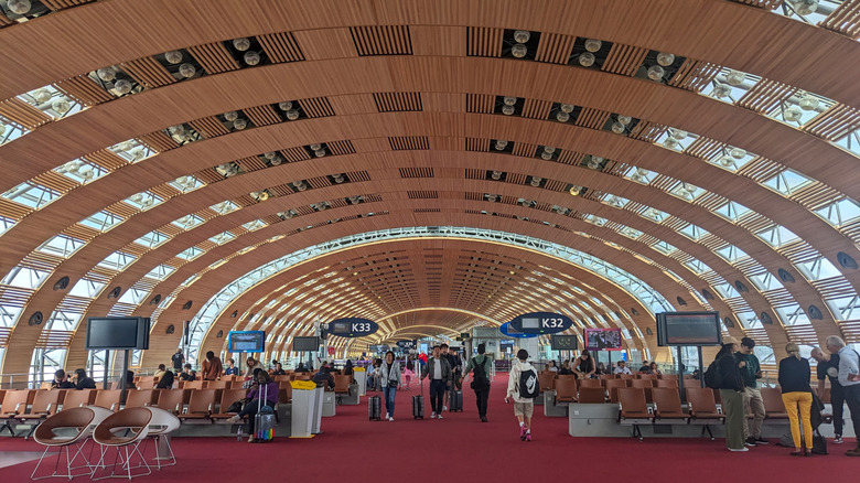 A modern terminal with a curved ceiling at Charles de Gaulle Airport