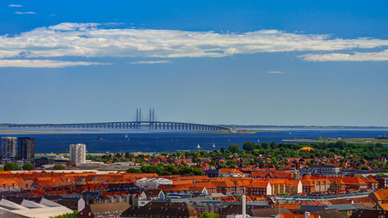 Copenhagen, Denmark city scape with Oresund Bridge, leading to Sweden, in the background