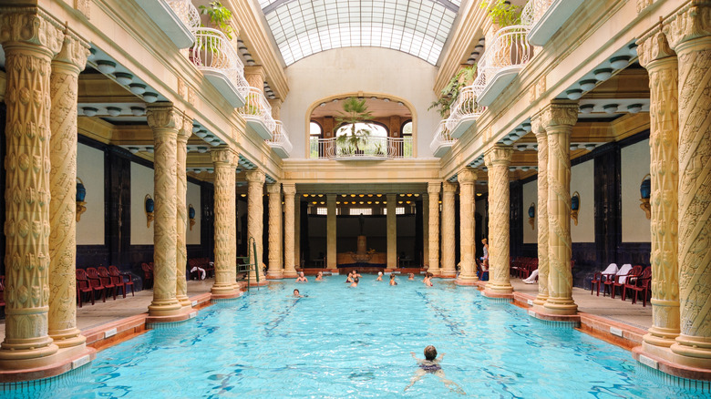 People swimming in a pool at the Gellert Bath in Budapest