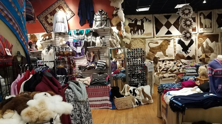 A shop filled with alpaca throws, knitwear, wall hangings, and toys at Mall of America.