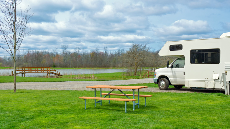 Indiana RV camper sitting in park next to a picnic table