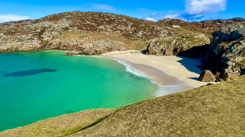 The clear waters of Scotland's remote Achmelvich Beach