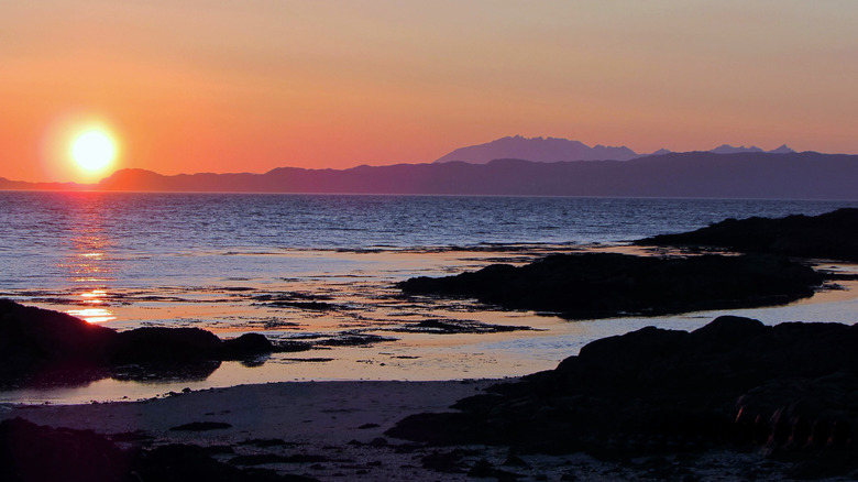 Camusdarach Beach with the sun setting over the Isle of Skye