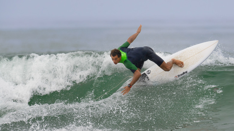 Close up of surfer in a wetsuit riding a wave at Trestles Beach, California.