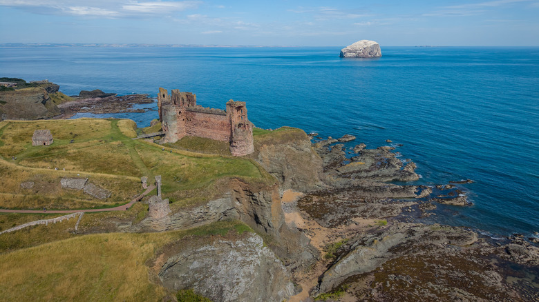 Tantallon Castle perched above the waters under a blue sky in East Lothian, Scotland
