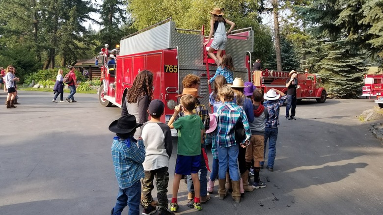 Kids exploring a fire truck at Flathead Lake Lodge in Bigfork, Montana