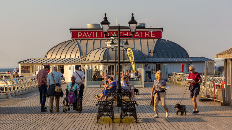 People walking in front of the Pavilion Theatre at the end of Cromer Pier in Cromer, England
