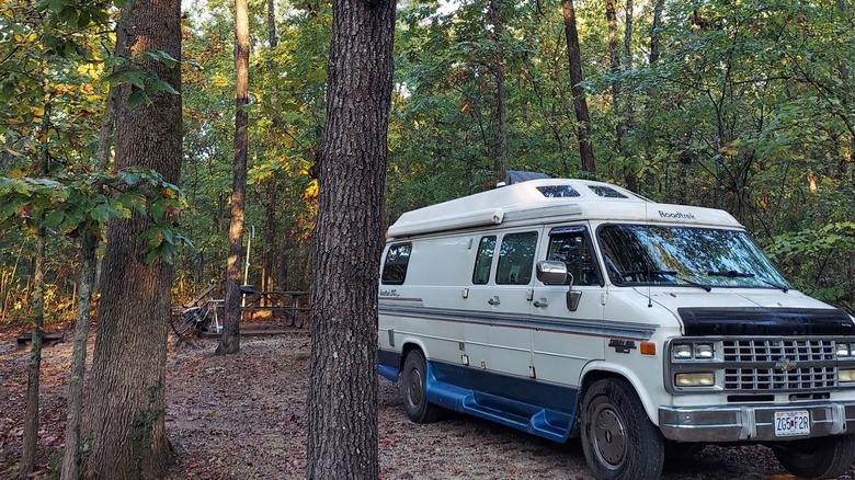 Camper van parked among the trees at a campsite at Robertsville State Park, Missouri
