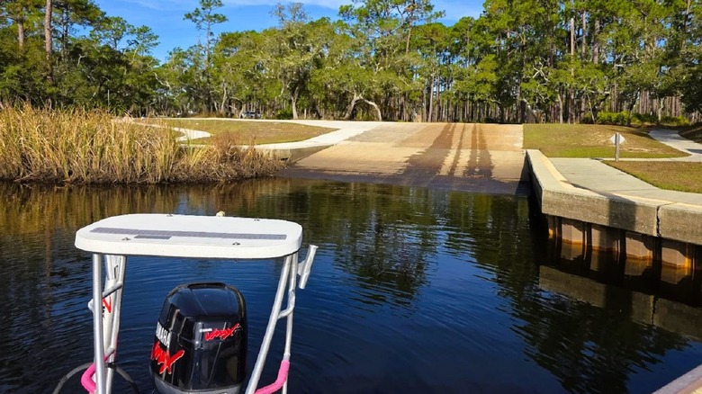 A boat ramp surrounded by trees at Ochlockonee River State Park in Florida, with views of brackish water.
