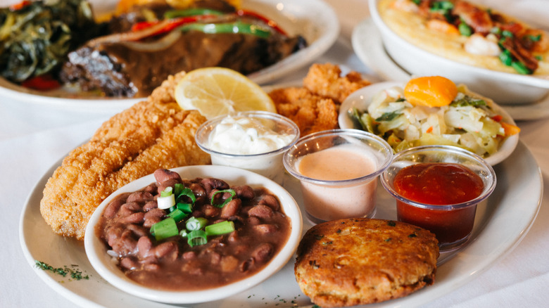 Southern cuisine including catfish, salmon croquettes, smothered cabbage, and red beans.