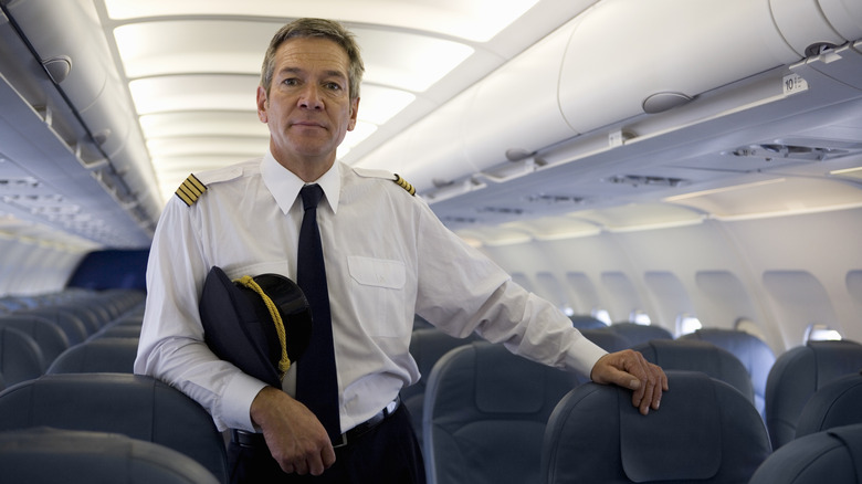 Pilot standing on an empty plane.