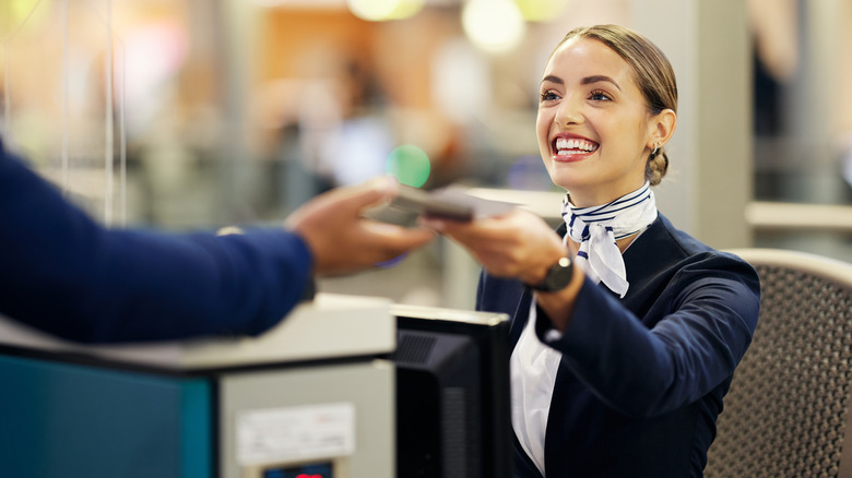 Airport staff talking to a passenger