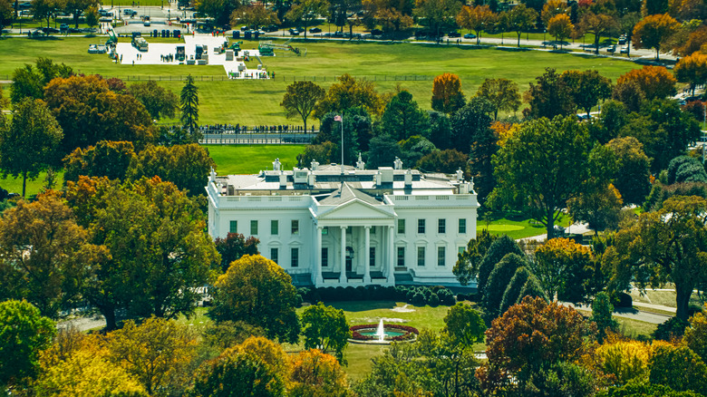 Helicopter shot of the White House in Washington, D.C. on a hazy afternoon in Fall.