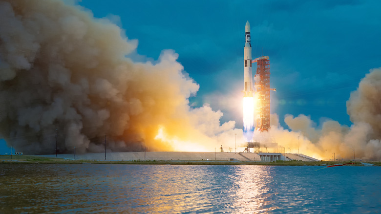 A rocket takes off into the sky as seen from a safe distance