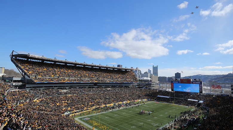 A view of a football field during a fly over by F-16 jets just before kick-off