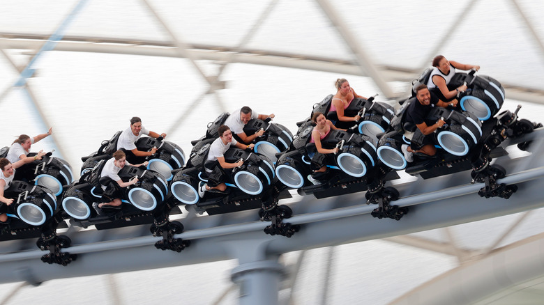 People riding the Tron Lightcycle Power Run rollercoaster