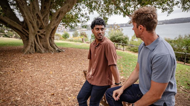 Two men talking in a park in Australia