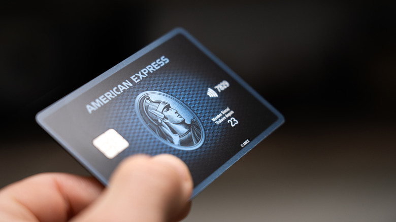 A person holding an Amex card