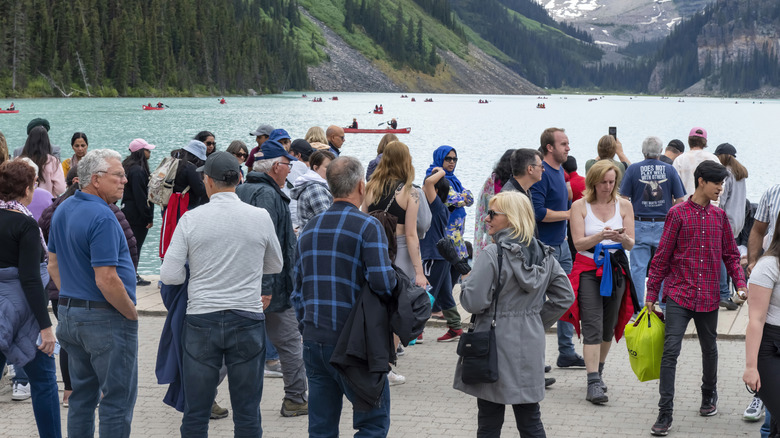 Numerous tourists on the shore of Lake Louise in Banff National Park