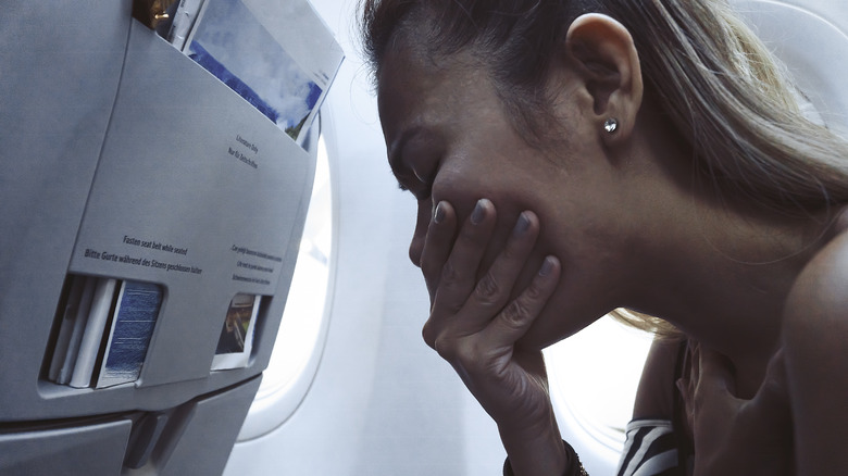 Nauseous woman on plane 