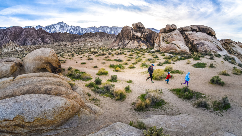 A mother and two children hiking in the Alabama Hills in the eastern Sierra Nevada in California