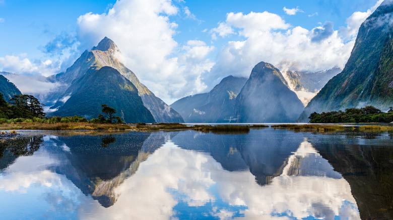 A lake with mountains reflected in the water in Fiordland National Park, South Island, New Zealand