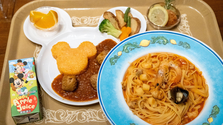 Mickey Mouse-shaped meal with spaghetti, meatballs, and juice box on a tray at Tokyo DisneySea