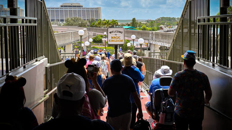 People walking into the Magic Kingdom park at Disney World from the monorail station