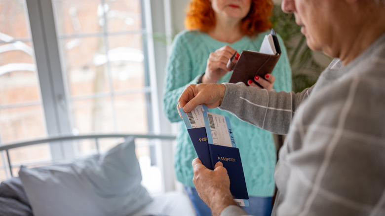 Couple sorting out their passports and flight tickets