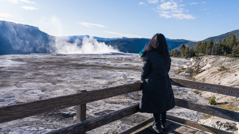 A woman wearing a winter jacket in Yellowstone