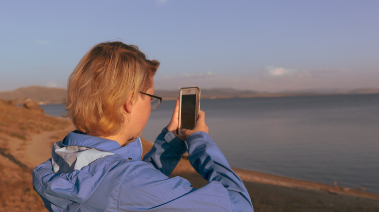 Woman with a cellphone iin Yellowstone