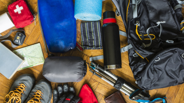 Equipment that would fit into a backpack to go out on a trail in the mountains